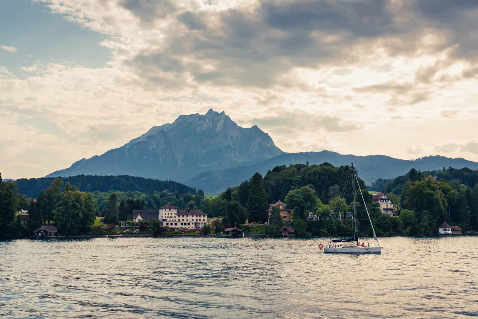Mount Pilatus seen fro Lake Lucerne. Sail boat in the foreground Mount Pilatus seen fro Lake Lucerne. Sail boat in the foreground