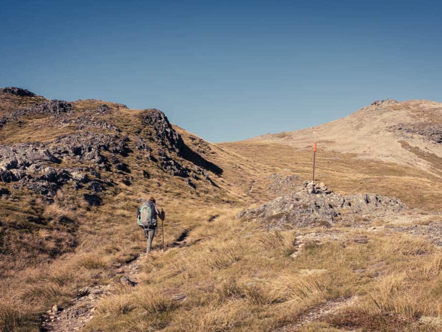 Hiker walking route up to Travers saddle