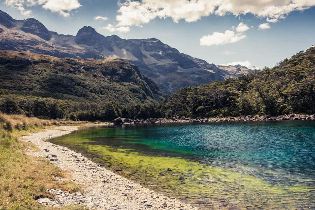 Blue Lake (Rotomairewhenua) in front of mountain range at upper Sabine valley